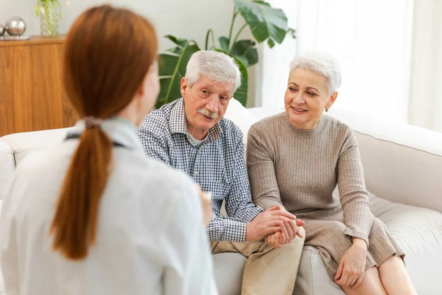 An older couple talking through Medicare choices with someone at home