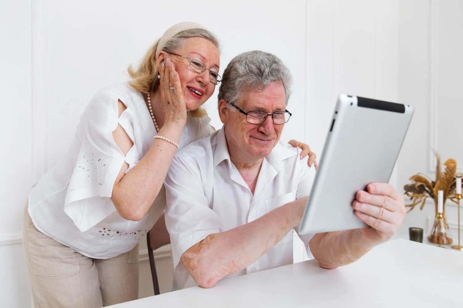An older couple looking at plan details on a tablet