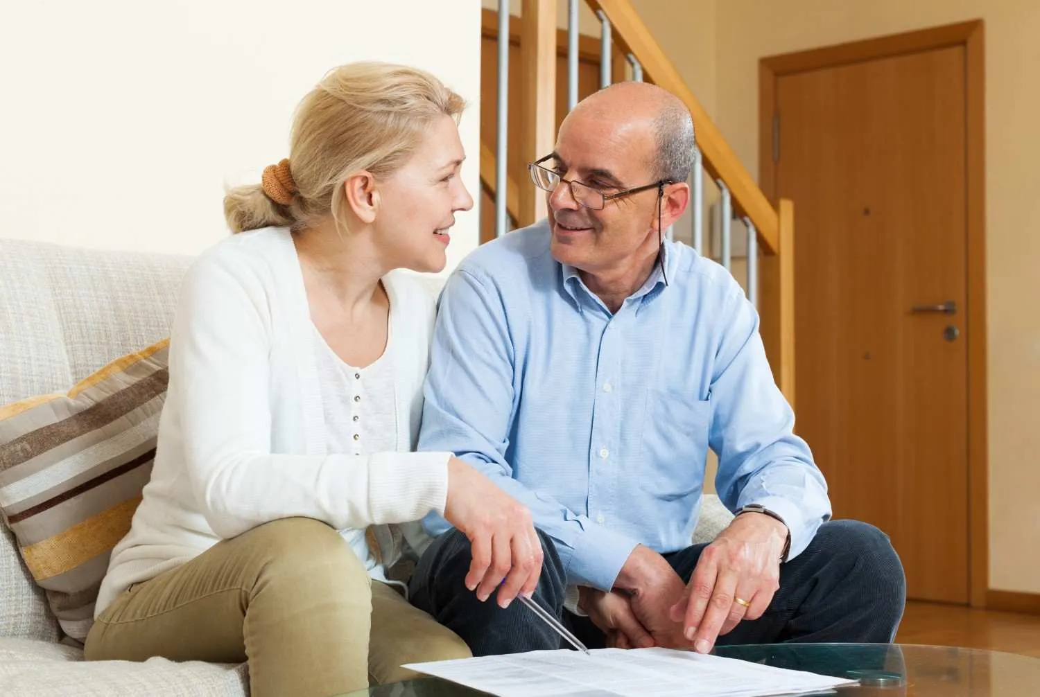 A couple at home comparing Medicare plan papers